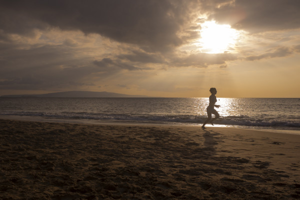 running on beach in Maui